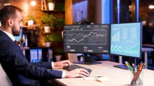 Virtual CFO strategizing with a business owner, surrounded by financial documents and digital analysis tools.